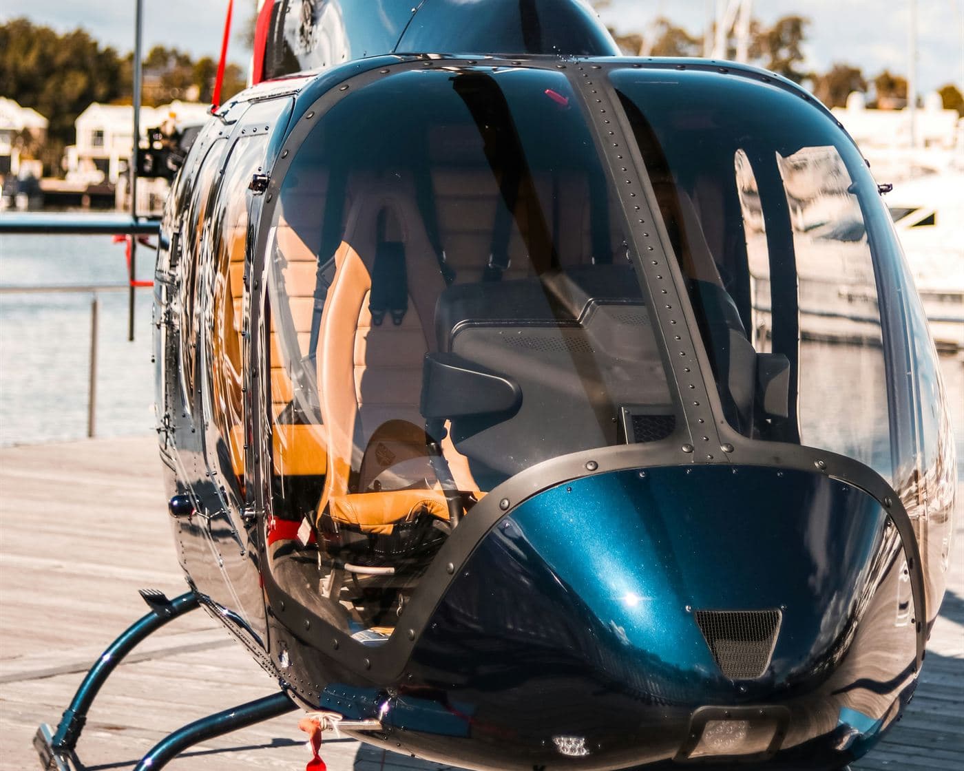 A helicopter parked at a waterfront marina